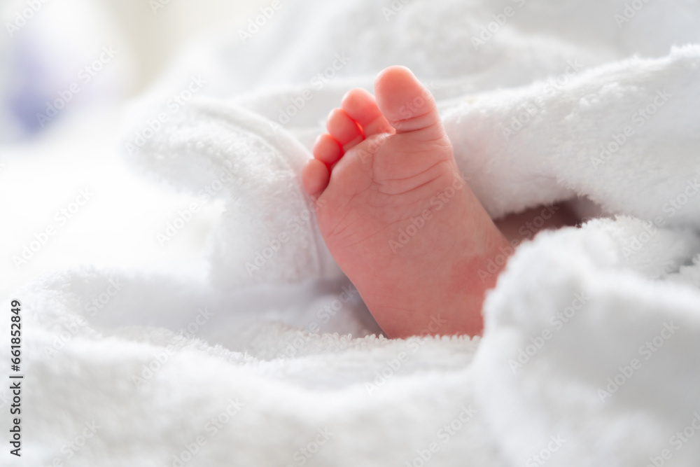 Soft white towel's secret: baby foot peeking post bath Soft white towel's secret: baby foot peeking post bath