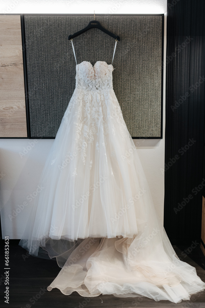 Bridal dress hanging on display in the hotel room before the wedding Bridal dress hanging on display in the hotel room before the wedding