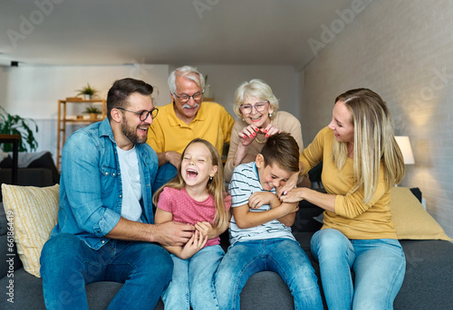 child family portrait woman mother man father grandmother daughter group smiling happy adult girl grandparent generation female grandchild together senior grandfather son boy three