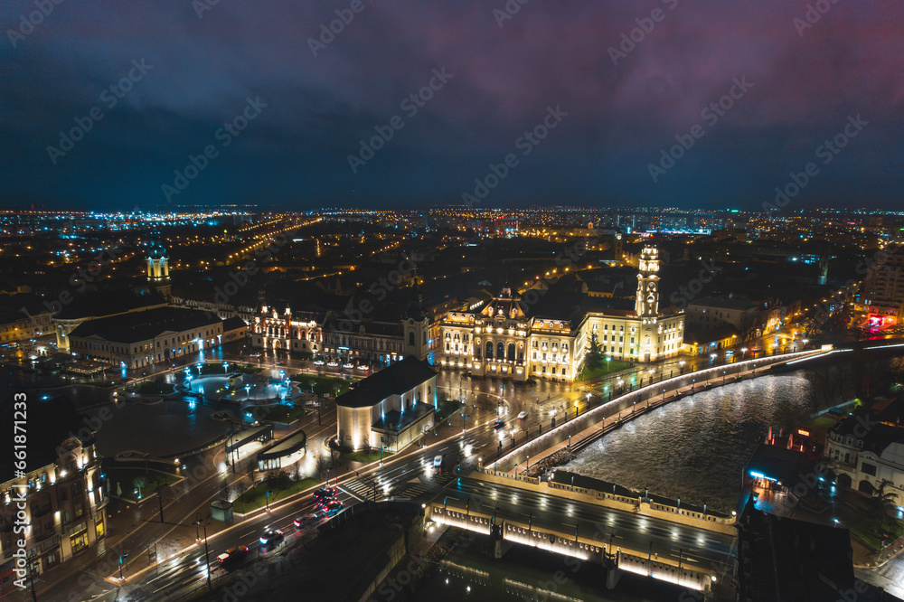Naklejka premium Oradea romania tourism aerial a mesmerizing nighttime cityscape showcasing the historic attractions of Europe