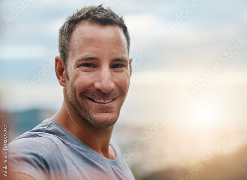 Portrait, space or happy man in an outdoor selfie with confidence or freedom on holiday vacation. Face, sunrise blur or person hiking in summer to travel or taking photograph or picture for memory
