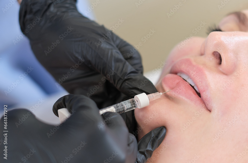 Beauty specialist administering a lip volumizing shot. When the quest for beauty challenges personal safety. Beauty specialist administering a lip volumizing shot. When the quest for beauty challenges personal safety.