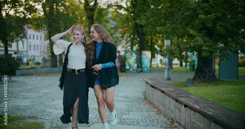 Wallpaper Mural Female friends walking in park during sunset Torontodigital.ca