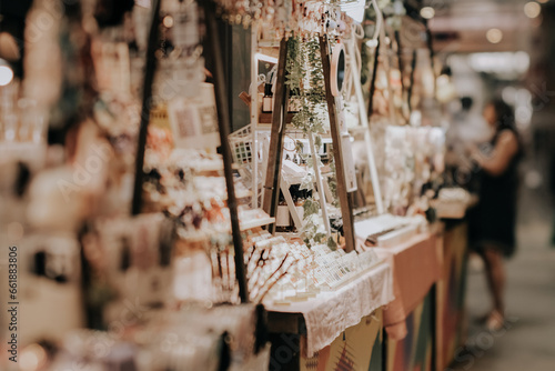 Indoor festive weekend market. Social pop up event of entrepreneurs and makers selling their goods at their booths in shopping mall. Captured with a tilt-shift lens. Selective focus; bokeh effect photo