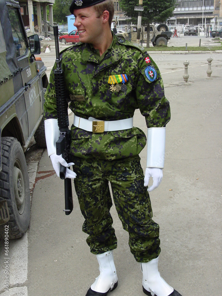 Fototapeta premium Military, officer and soldier in the army with uniform, smile and weapon for service, mission or hero. Government, man and happiness for career, pride and protection outdoor in nature with rifle