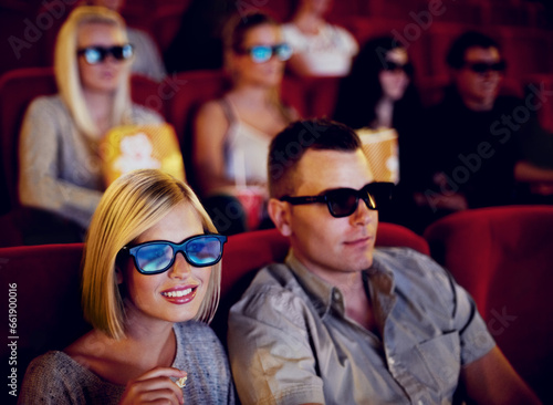 Cinema, 3d glasses and couple watching film, eating popcorn and romantic date together. Movie night, man and woman with smile in theater, snacks and eyewear, sitting in auditorium to relax at show.