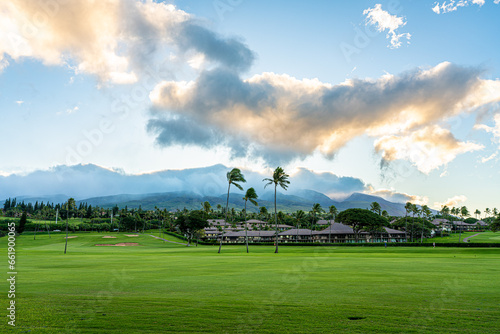 Maui, Hawaii at dusk with mountains and palm trees 