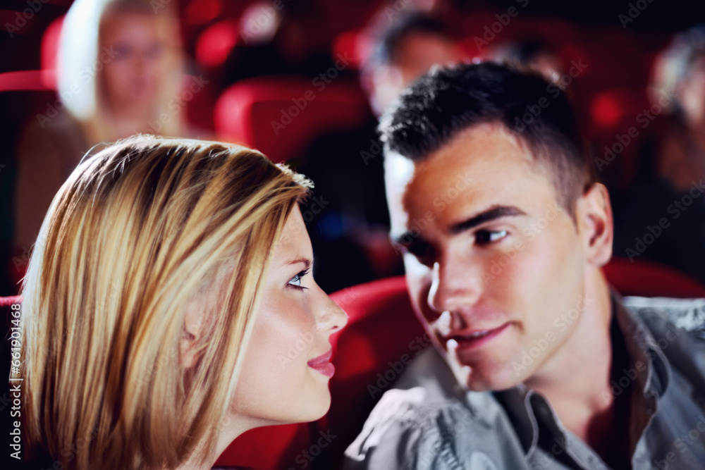 Naklejka premium Cinema, romance and couple watching film, love and romantic date together. Movie night, man and woman in theater with smile, attraction and sitting in auditorium to relax at show with happiness.