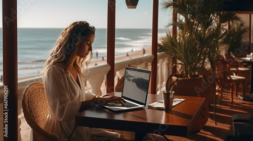 Beautiful woman works at a laptop at a coastal cafe. Concept of successful young independent woman. AI