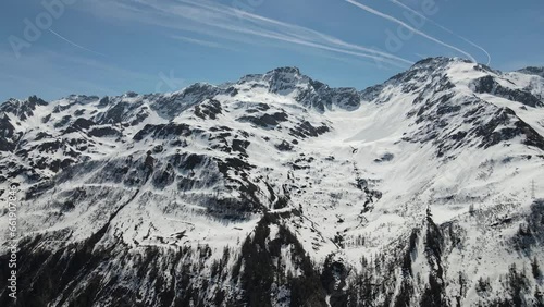 Panoramic view of majestic Snow-Covered Alpine Peaks Beneath Clear Endless Skies in Switzerland in Ticino featuring Poncione di Valleggia and Cristallina in serene winter landscape  photo