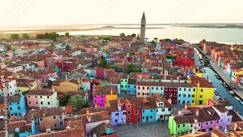 Aerial view of Burano Island, colorful houses, Church of Saint Martin Bishop and Campanile at sunrise golden hour, Venice, Veneto Region, Italy