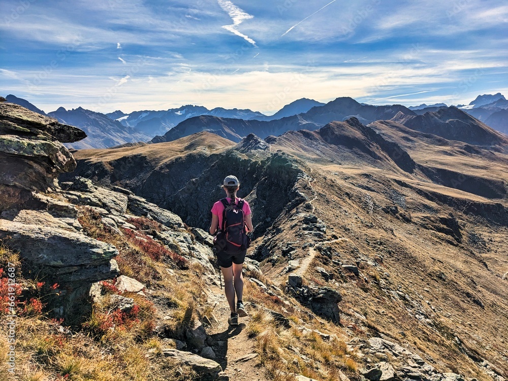 Hiking on the mountain ridge from Jakobshorn towards Tällihorn in the Davos Klosters Mountains. Breathtaking view of the Sertig and Dischma valley. High quality photo