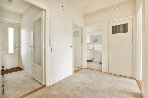 an empty room with white walls and door handles on the doors are closed to let in light into the room