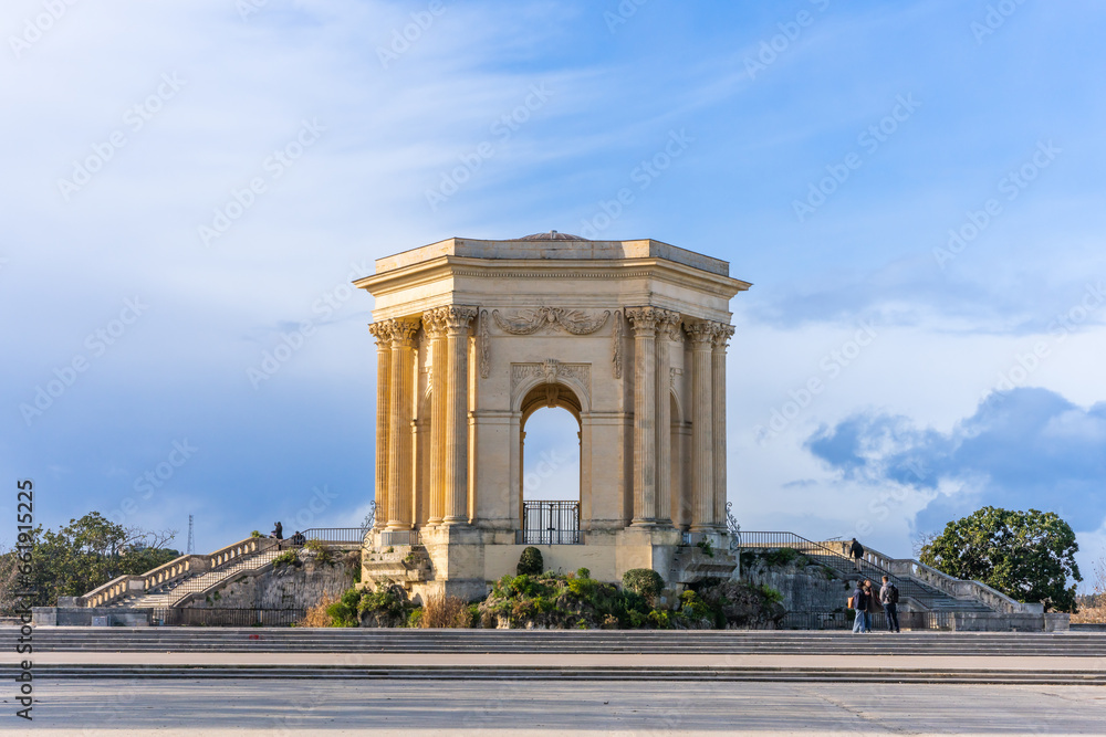 Montpellier, France - January 16 2023 - The Château d’eau du Peyrou at the Bassin principal du Peyrou. The water building and pond at the promenade du Peyrou - obrazy, fototapety, plakaty 