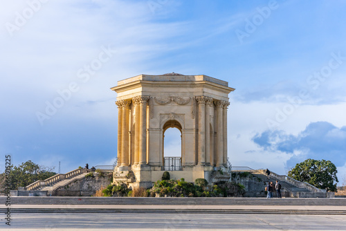 Montpellier, France - January 16 2023 - The Château d’eau du Peyrou at the Bassin principal du Peyrou. The water building and pond at the promenade du Peyrou © ivoderooij