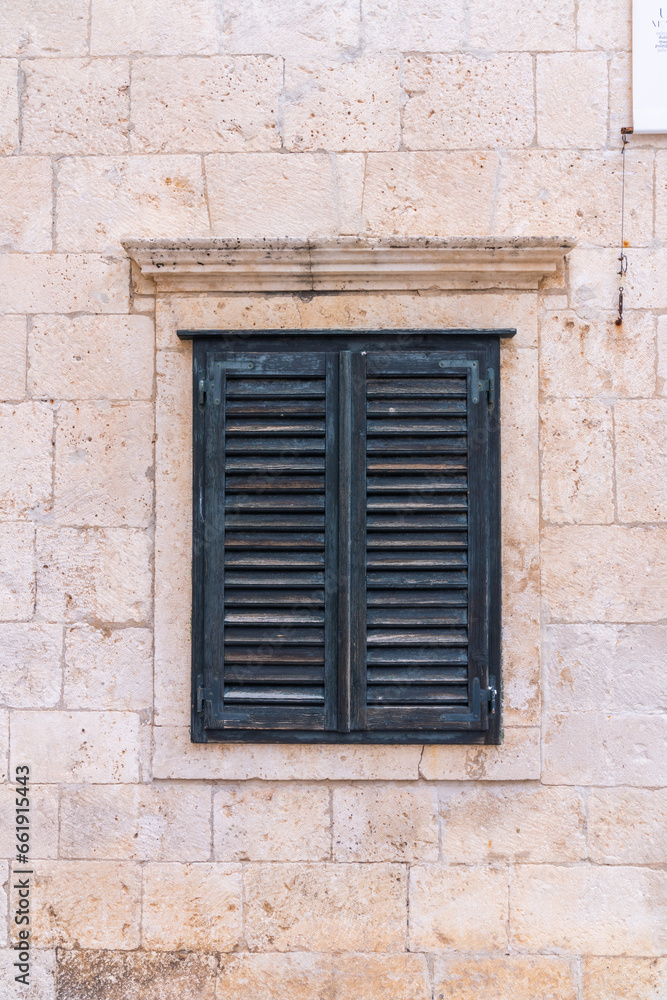 Fototapeta premium Old shutters in front of Medeival windows in the town of Dubrovnik, Croatia