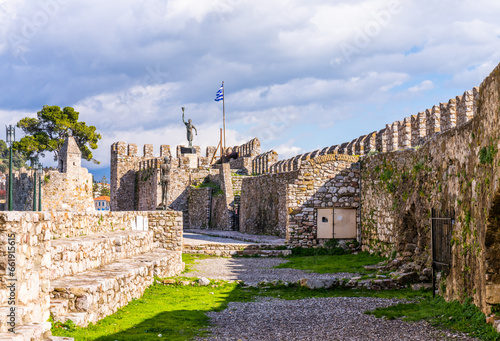 Fototapeta Naklejka Na Ścianę i Meble -  Nafpaktos, Greece - 4 february 2023 - The old city at the waterfront of the old venetian town with in the background the statue of Miguel de Cervantes Monument