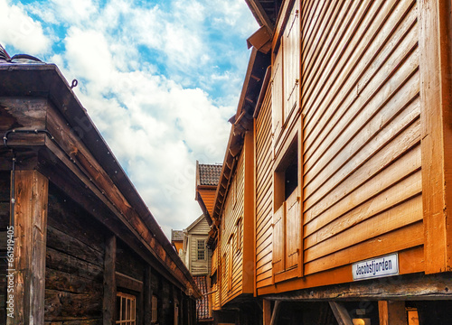 Hanseatic commercial wooden buildings on each side of passageway Bryggen Bergen Norway UNESCO world Heritage Site