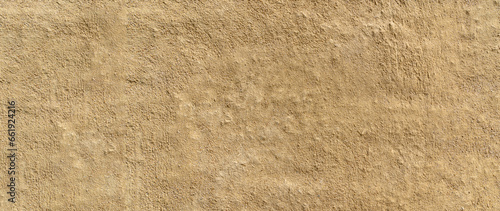 Clay wall of a clay house structure background. Brown clay mud grunge cement texture wall.