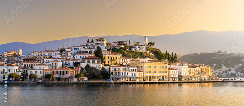 Poros, Greece - 17 February 2023 - View on the town of Poros on Poros island seen from the mainland at sunset