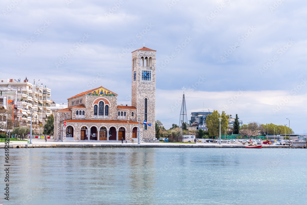 Volos, Greece - 16 March 2023 -Orthodox church of St. Constantine and Elena seen from the water