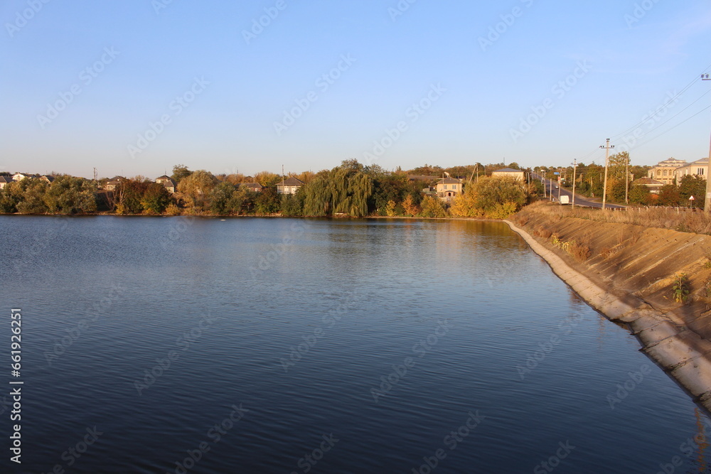A body of water with trees and houses