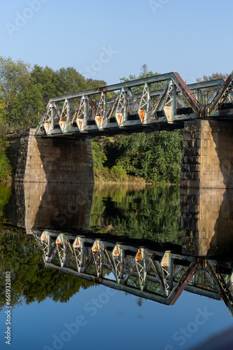 Old bridge over river with reflection