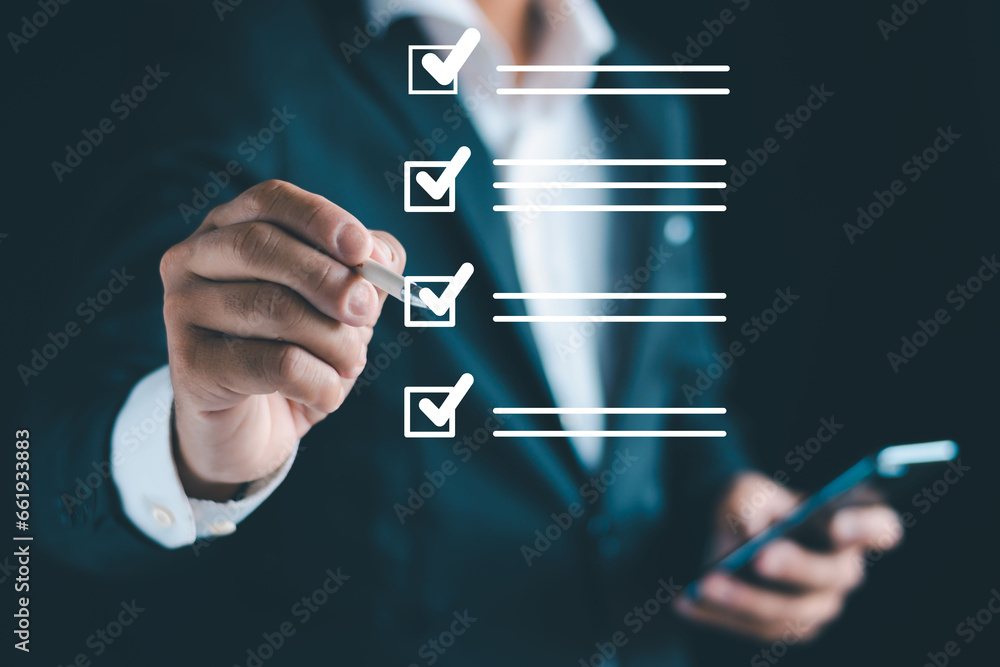 Business performance checklist, businessman using smartphone, taking ...