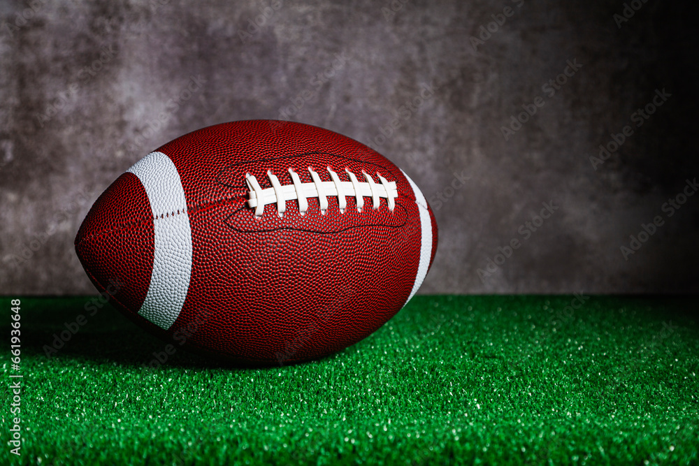An American Football ball over grass An American Football ball over grass
