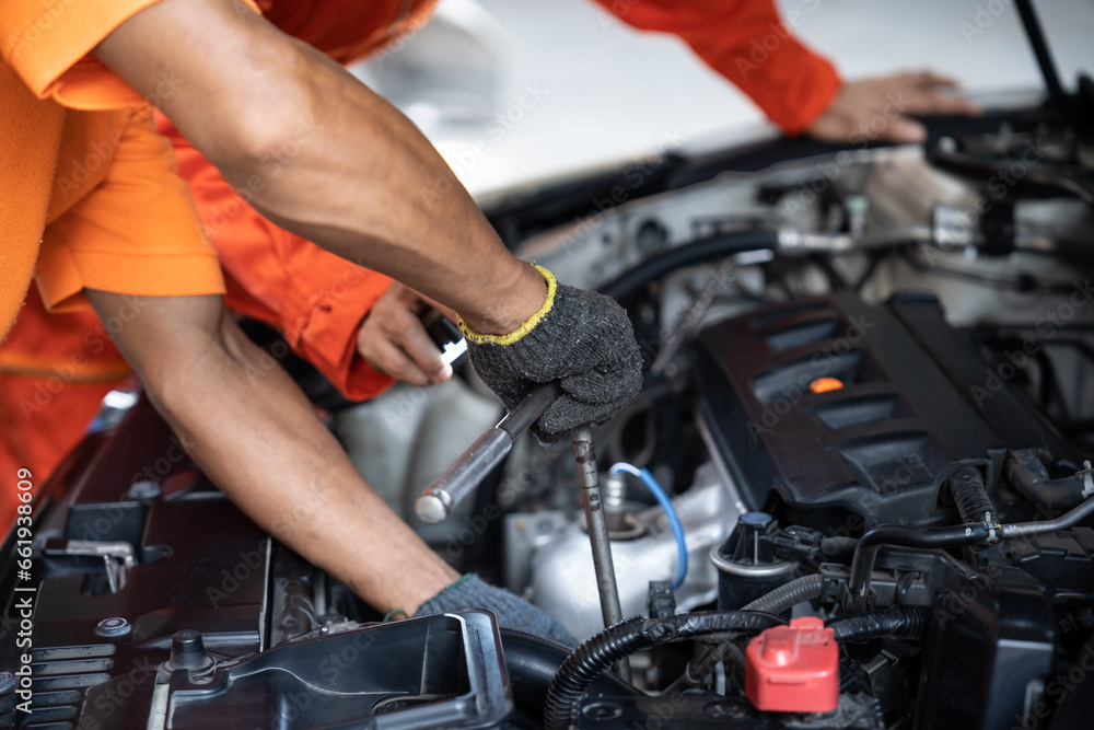 Automotive service mechanic inspect and diagnose car engine issue, repairing and fixing problem in garage workshop. Technician car care maintenance working on internal components of vehicle. Oxus