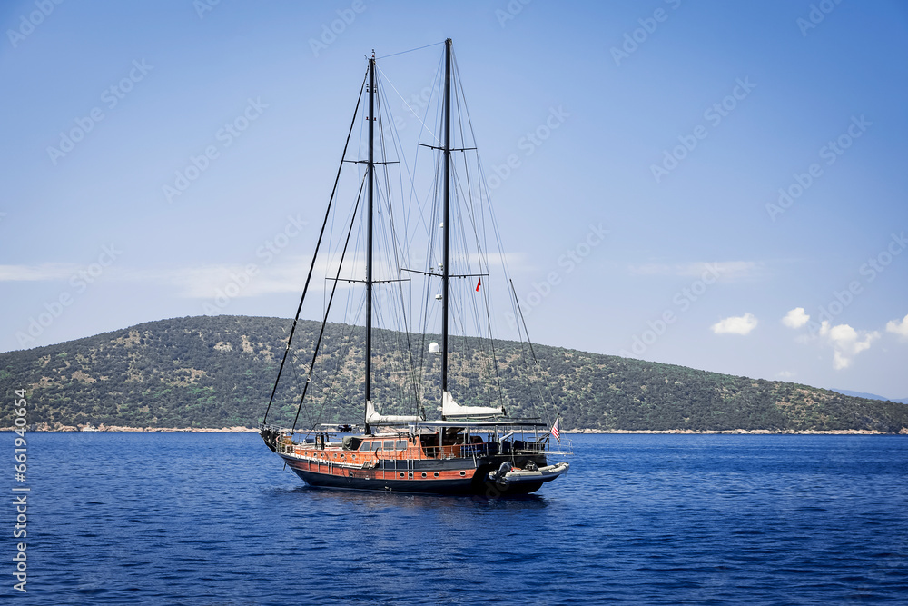 a beautiful sailing boat stopped in the quiet bay of Bodrum enjoying the splendid panorama on a sunny day a beautiful sailing boat stopped in the quiet bay of Bodrum enjoying the splendid panorama on a sunny day