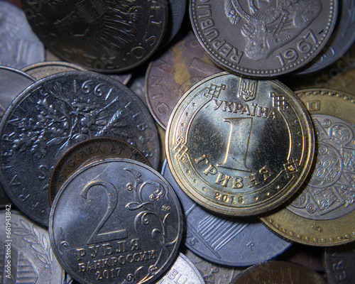 Ukraini hryvnia coin on a pile of world coins photo