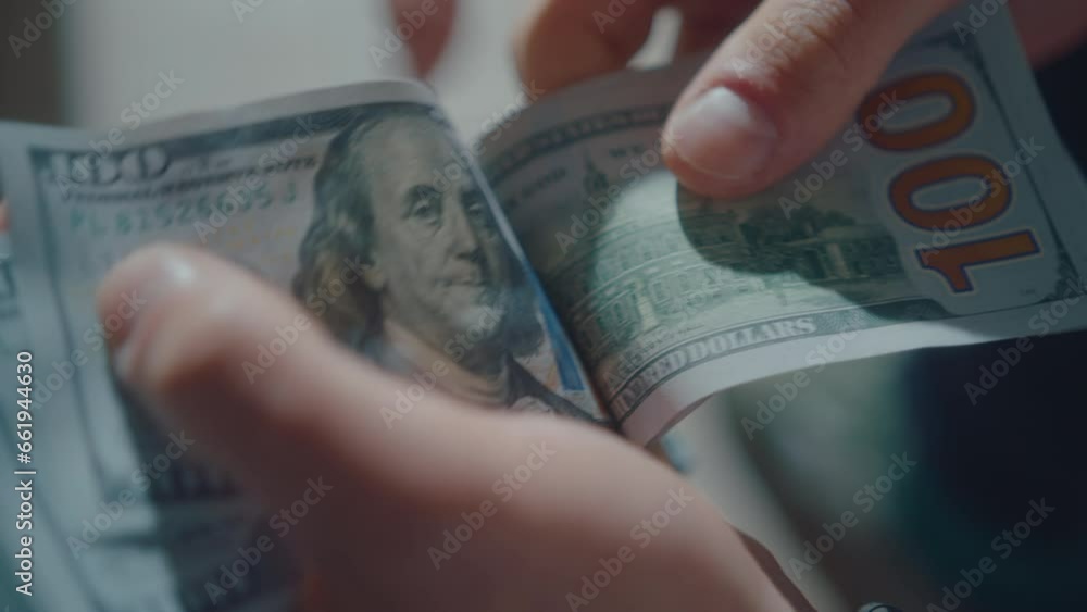 Hands of businessman counting stack of hundred-dollar bills. Financial growth and successful business concepts