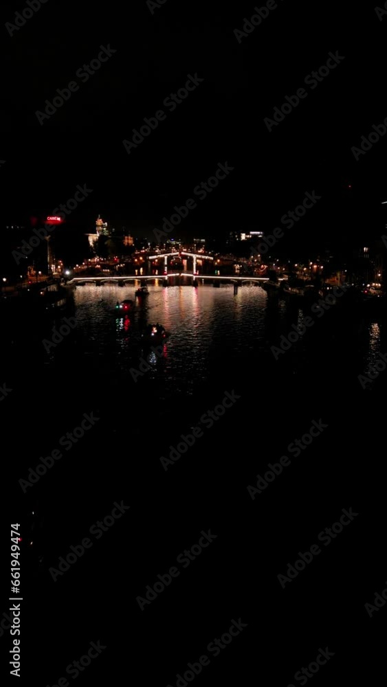 flying a drone over the night city. Illuminated streets, lights in the windows. Amsterdam nightlife. vertical video flying a drone over the night city. Illuminated streets, lights in the windows. Amsterdam nightlife. vertical video