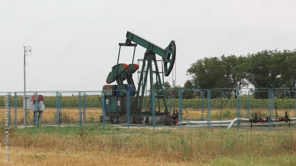 Pumping Oil Well Pump Jack at Field Pumpjack in Vojvodina Pumping Oil Well Pump Jack at Field Pumpjack in Vojvodina