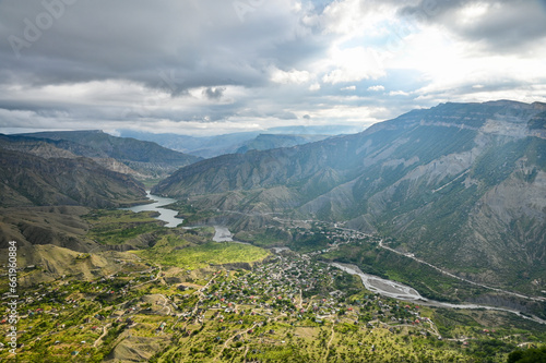 Beautiful landscape with mountains, valley and a river on a sunny summer day with clouds. Dagestan