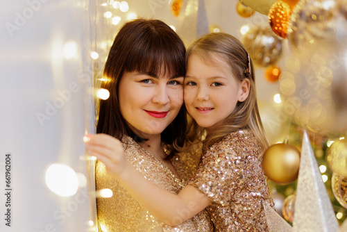 Mother and daughter posing in christmas decorations