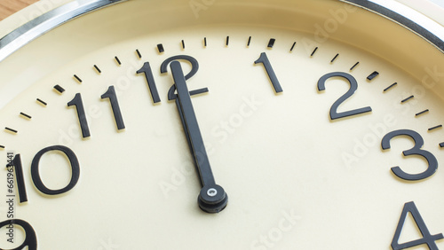 analog clock hands indicating  00:00 or 12:00 photo