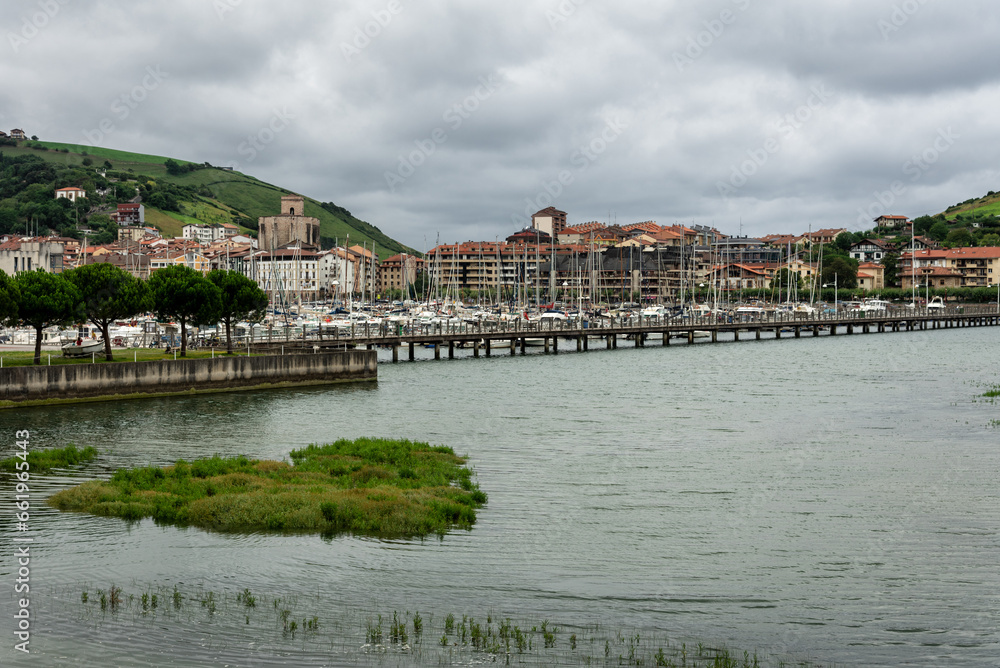 Skyline of the Zumaya village with the marina crowded of boats in Urola estuary in the foreground on a stormy day, Gipuzkoa, Basque Country, Spain Skyline of the Zumaya village with the marina crowded of boats in Urola estuary in the foreground on a stormy day, Gipuzkoa, Basque Country, Spain