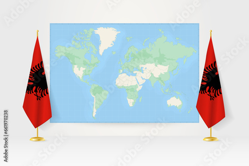 World Map between two hanging flags of Albania flag stand.