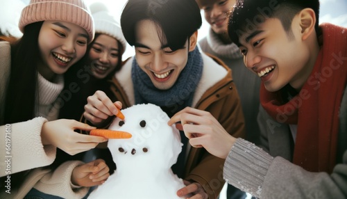 Close-up photo of a diverse group of individuals working together to construct a snowman.