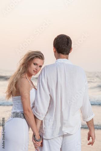 Happy Romantic Young Couple Enjoying Beautiful Sunset on the Beach