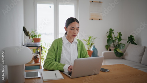 Focused blogger typing laptop at home close up. Girl working modern computer