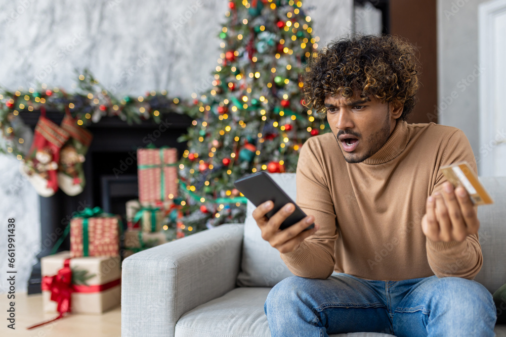 Cheated and upset Christmas man in living room near decorated Christmas