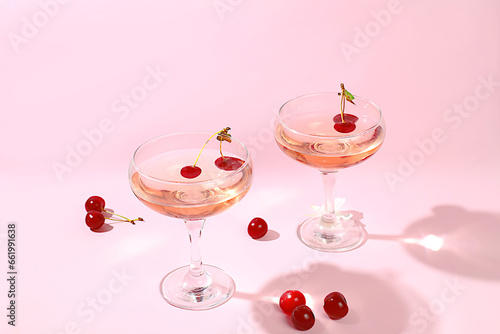 Modern still life with rose wine, alcoholic cocktail and cherry berries on elegant modern background, minimal concept for bar and holiday party, cafe, advertising banner, selective focus,