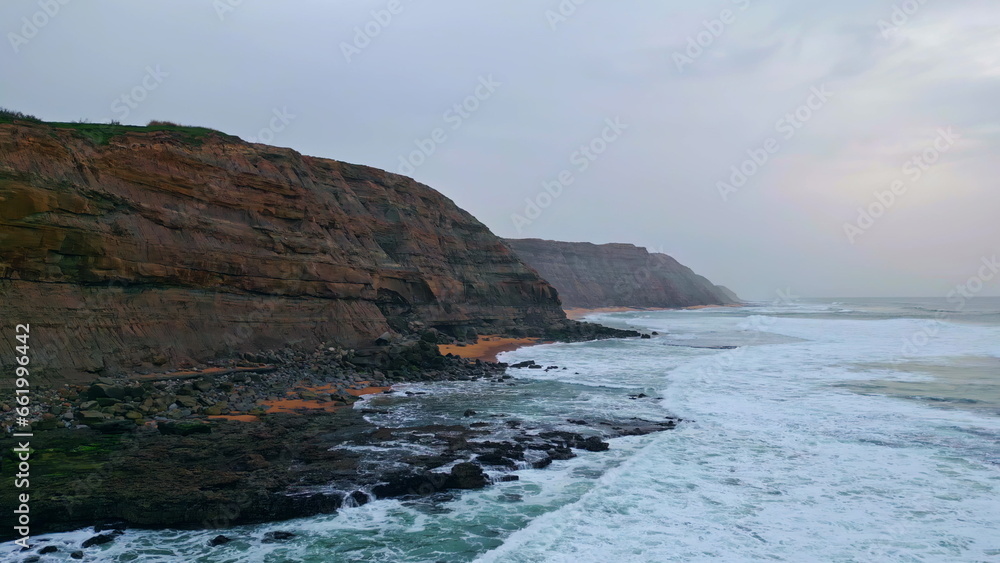 Drone view ocean thunder sky scenery. White foaming sea waves breaking coastline