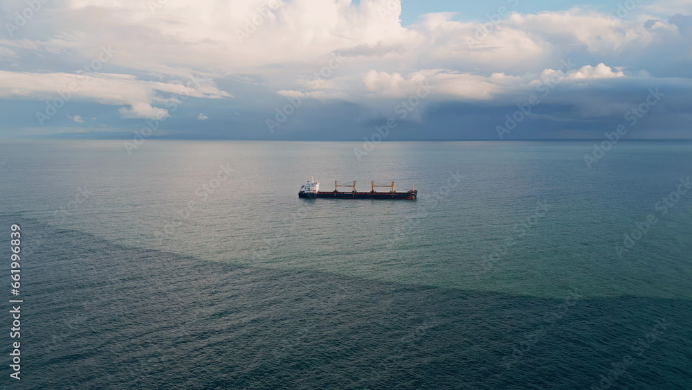 Aerial view ship sailing gloomy horizon slow motion. Vessel floating calm ocean