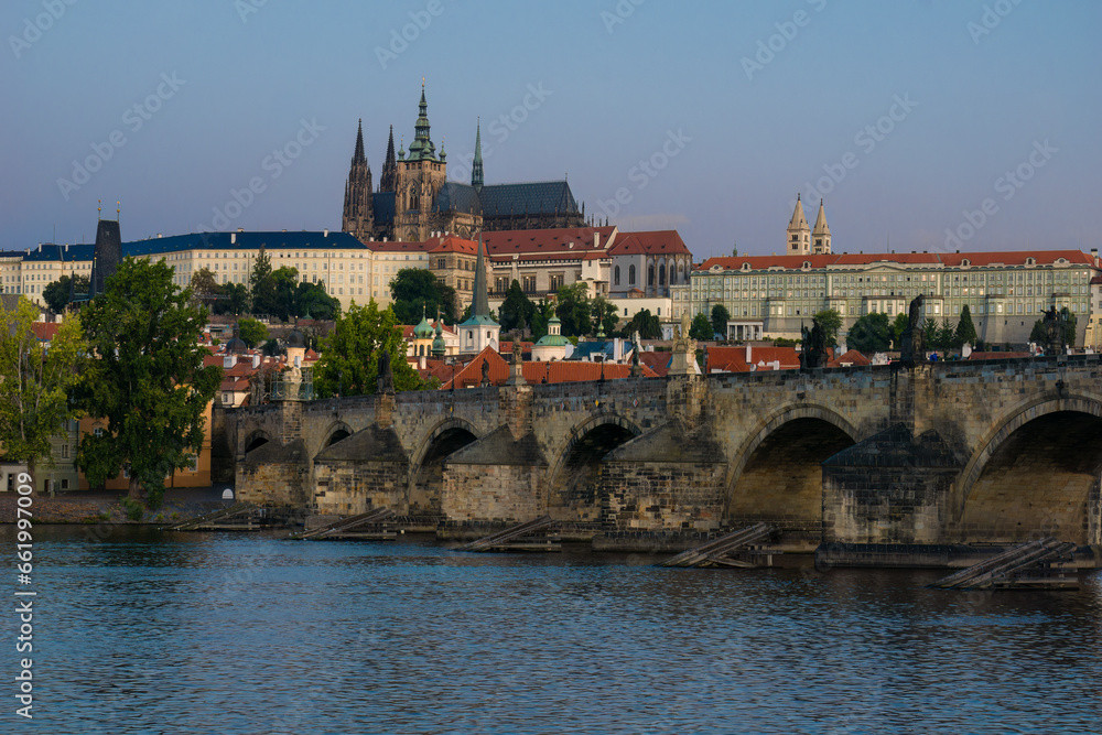 Panoramic view from the Vltava River to the historic Prague Castle and bridge of Charles in the morning sun