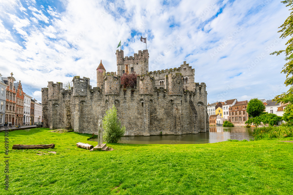 The medieval Gravensteen castle along the Leie River on a sunny summer day in the East Flanders city of Ghent, Belgium.	