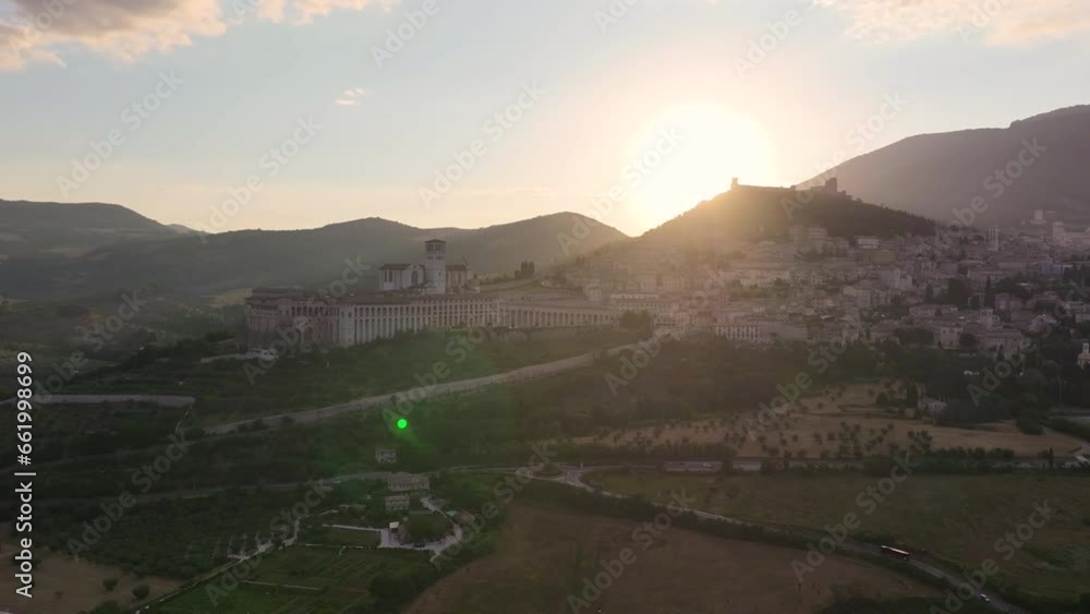 Aerial panorama of Assisi, featuring the Basilica of St. Francis, Rocca Maggiore, Santa Maria sopra Minerva Church, and Cathedral of San Rufino on a summer morning, Umbria, Italy